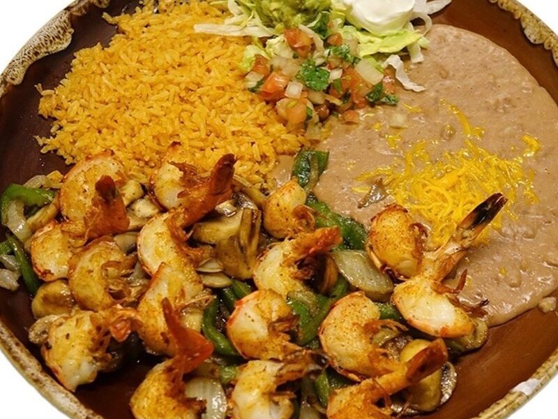 Jumbo prawns grilled with mushrooms, onions and bell peppers, served with rice and beans